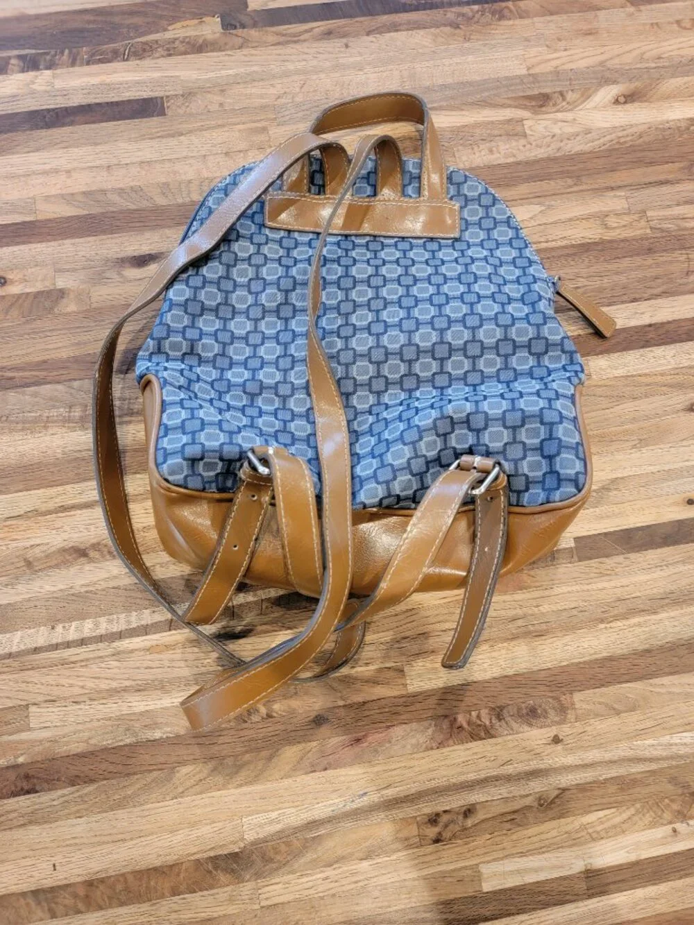 Nine West backpack purse featuring a geometric pattern and brown faux leather tr